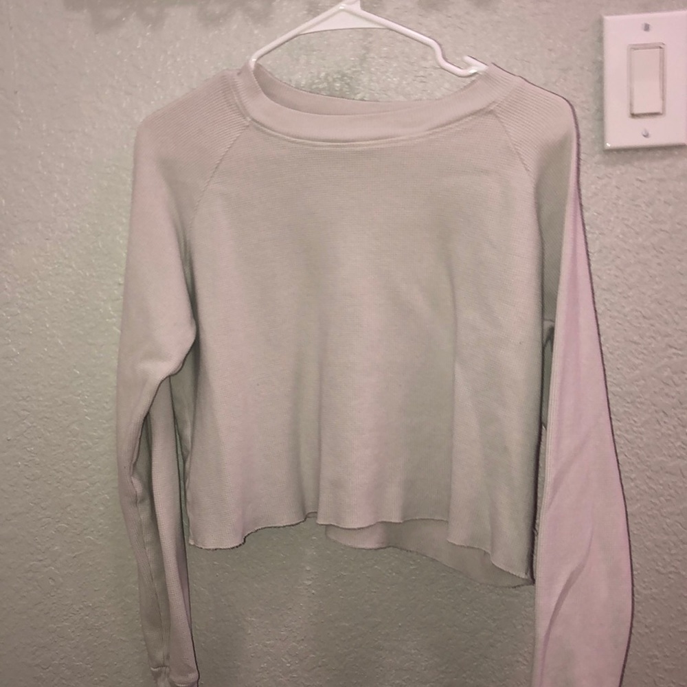 A long sleeve gray cropped sweater
